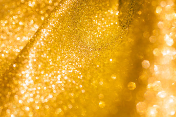 Golden glitter christmas abstract background. Shiny golden lights