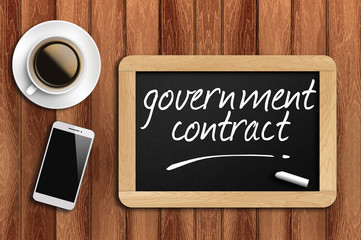 coffee, phone  and chalkboard with word government contract - 94813879