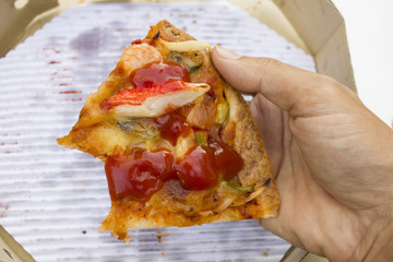 Pizza bite last one left on the hand