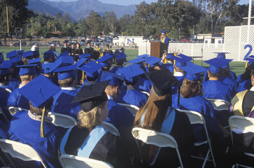 Rear view of the caps and gowns of UCLA's professors during graduation ceremony, Los Angeles, CA