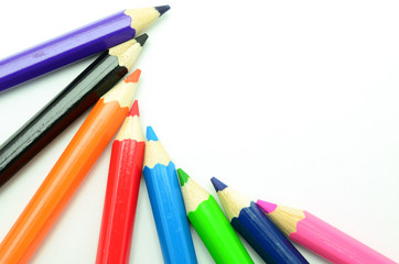 Fototapeta premium Colorful vertical pencil crayon border over white