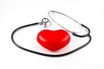 Medical stethoscope and heart on white background