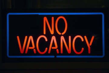 Neon sign reads ÒNo VacancyÓ for a motel at night