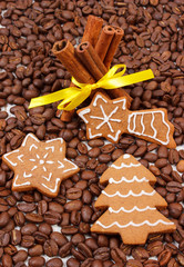 Decorated gingerbread and cinnamon sticks on coffee grains, christmas time