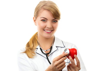 Woman doctor with stethoscope examining red heart, healthcare concept