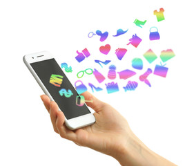 Hand holding smartphone with market icons, isolated on white