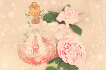 Rose oil in bottle on color background