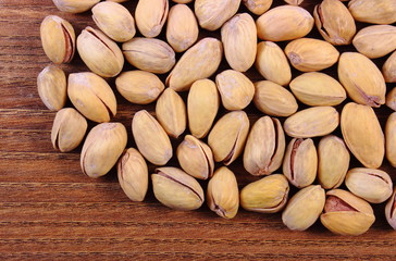 Pistachio nuts on wooden table, healthy eating