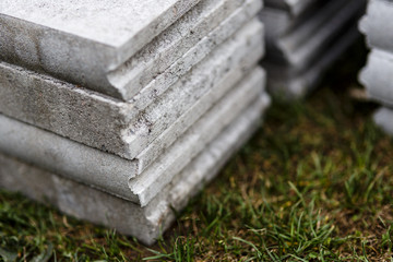 stack of concrete curb on the grass