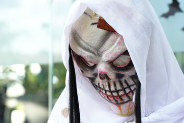 skull ghost under white fabric