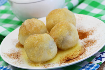 Sweet dumplings sprinkled with sugar and cinnamon, closeup

