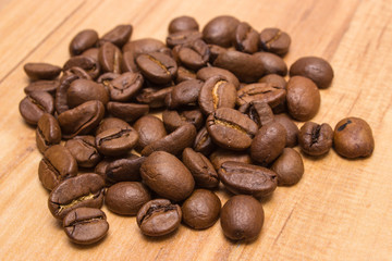 Heap of coffee beans on jute canvas on table