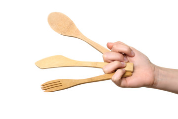 wooden kitchen utensils in his hand at the woman on white isolated background