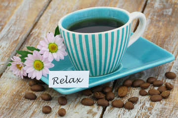 Word relax with cup of coffee and pink daisy flowers
