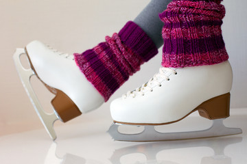 Female legs in gaiters and ice skates