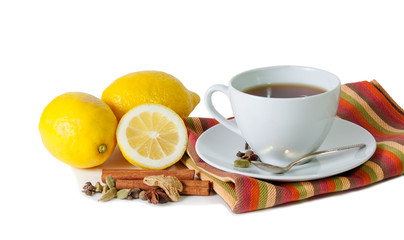 Black tea with lemon and spices isolated on white