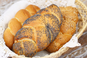 Challah bread with poppy seeds, sesame seeds and plain in bread basket
