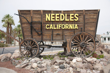 Covered wagon welcomes drivers to Needles California sign and Route 66, California .