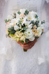 beautiful wedding bouquet in the hands of the bride