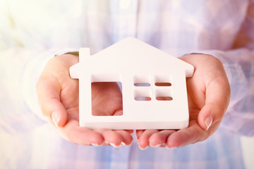 Female hands holding house, closeup