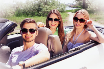 Three friends in cabriolet, outdoors