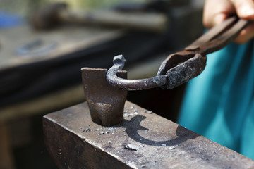 blacksmith makes a horseshoe  close-up