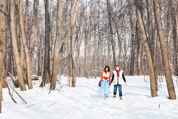 boy and girl   in winter forest. Christmas time and winter fairy tale