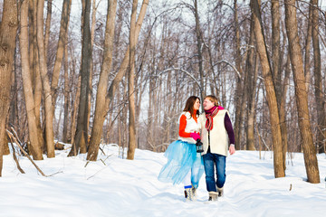 Fototapeta na wymiar boy and girl in winter forest. Christmas time and winter fairy tale