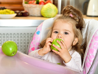 Fototapeta na wymiar Feeding baby. Baby food. Green apple.