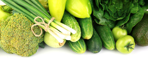 Heap of green vegetables isolated on white