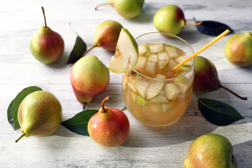 Fresh pear juice with fruit on table close up