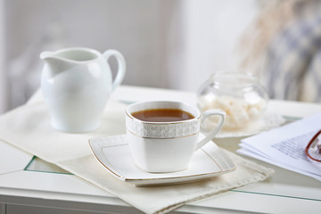 Cup of coffee on table in living room