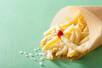 french fries with ketchup over green background
