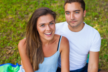 Pretty girl and her boyfriend are cuddling in park