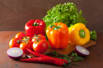 healthy vegetables pepper tomato salad onion on rustic backgroun