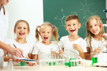 Cute pupils doing biochemistry research in chemistry class