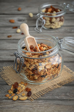 Homemade granola with nuts and raisins on the wooden table
