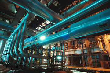 Equipment, cables and piping as found inside of a modern industr