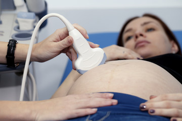 Pregnant girl doing on ultrasound examination