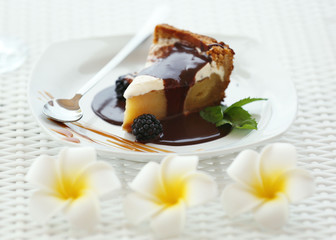 Delicious cake under chocolate glaze with blackberry and mint
