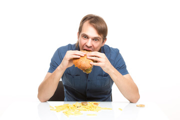 man is not careful eating tasteless burger. 