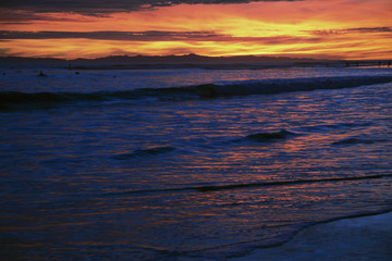 Fototapeta na wymiar Deep purple and orange sunset looking towards Anacapa Island, Ventura, California, USA, 12.16.2013