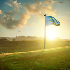 european union flag on sunset landscape 