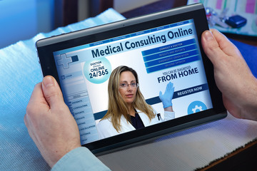hands of a man at a website of online health service in the tablet / man searching web internet for...