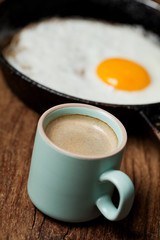 Breakfast setting with coffee and fried egg