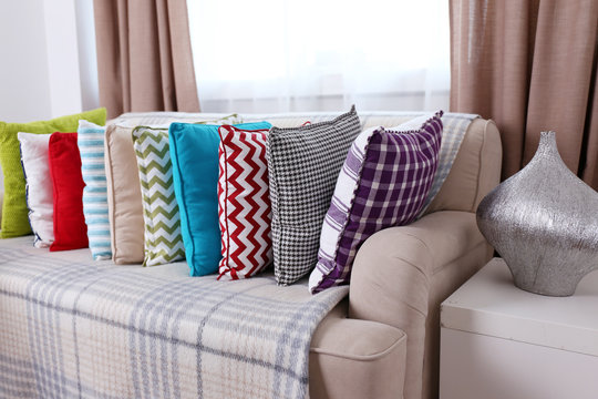 Sofa with beautiful colourful pillows in the room