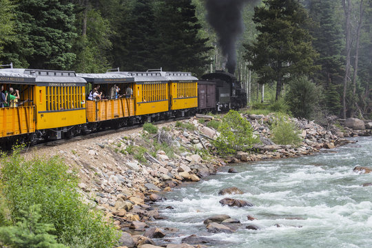 The Durango and Silverton Narrow Gauge Railroad Steam Engine travels along Animas River, Colorado, USA, 07.08.2014