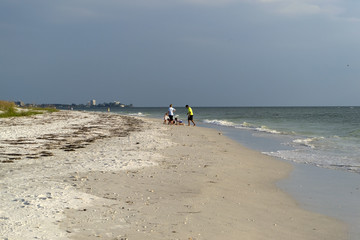 Family on white sand tropical beach having a holiday