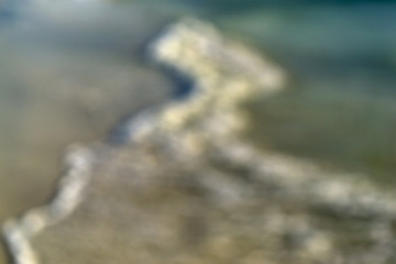 Wave breaking on tropical beach - blurred background