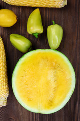 Yellow composition of fruit and vegetables on wooden background